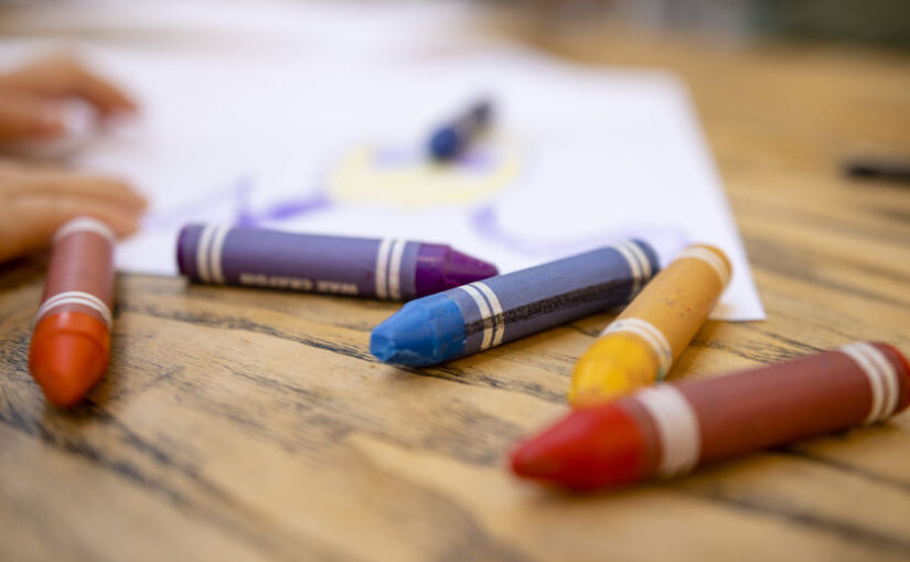 Colourful Crayons on Table. Photo SolStock / Getty